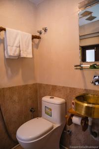 a bathroom with a toilet and a sink at Sweet Home Bhaktapur in Bhaktapur