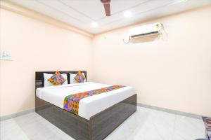 a white bedroom with a bed in a room at FabHotel Olive Inn I - 260m from Saltlake Sector V Metro Station in Kolkata