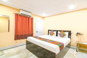 a bedroom with a large bed in a room at FabHotel Olive Inn I - 260m from Saltlake Sector V Metro Station in Kolkata