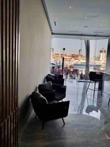 a room with chairs and a view of a building at Best View in Marina puerto Vallarta in Puerto Vallarta