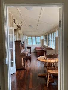 a living room with a table and a couch at Flame Hill Vineyard in Montville