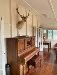 a wooden organ in a room with a deer head on the wall at Flame Hill Vineyard in Montville