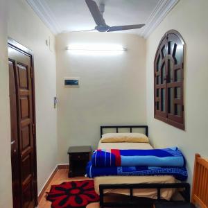 a bedroom with a bed and a ceiling fan at Amazing Mountain View-Near City Center in Luxor