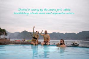 a group of three people sitting in a swimming pool at The One 'Private Island' Escape in Cat Ba