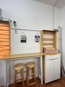 un escritorio en una habitación con dos taburetes en S&E-2 Tiny Guest House - Olango Island, en Lapu Lapu City
