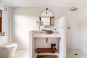 a bathroom with a sink and a toilet at Studio Birdsong in East Ballina