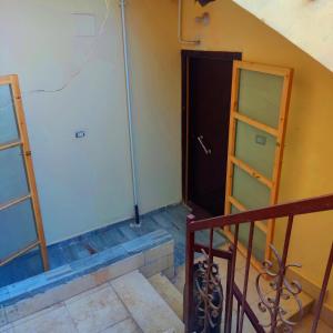 a room with a staircase and a door and a stair case at Amazing Mountain View-Near City Center in Luxor