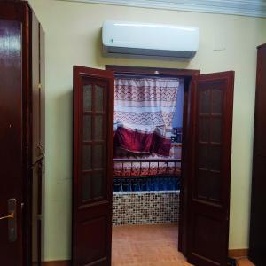a room with a closet with a curtain and a window at Amazing Mountain View-Near City Center in Luxor
