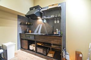 a kitchen with a sink and a counter at -時の宿 上七軒- Kyoto Machiya 金閣寺周辺 in Kyoto