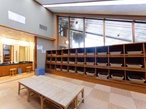 a room with a wooden table and shelves at Tabist Healthy Pal Akagi in Shibukawa