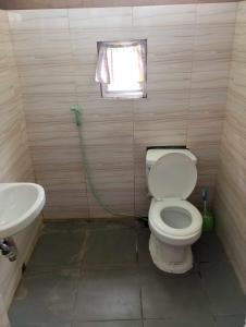 a small bathroom with a toilet and a sink at Private Aircon Rooms in Lagkaw Homestay in Looc +13 photos