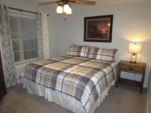 a bedroom with a bed and a lamp and a window at Lakefront Condo A-1 with Large Balcony in Hollister