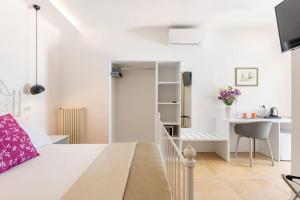 a small apartment with a bedroom and a desk at Villa Soleanna Residence in Vieste
