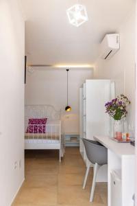 a small white room with a bed and a desk at Villa Soleanna Residence in Vieste