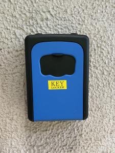 a blue key box with a yellow sticker on it at Naoshima J-House in Naoshima