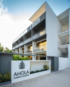 an office building with a aloha hotel in front of it at Ahola Thoddoo, Maldives in Thoddoo