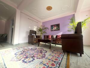 a living room with a couch and a rug at Notting Hill House Home Stay Shimla in Shimla