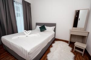 a bedroom with a large bed with a mirror and a mirror at K Avenue 4-5 Pax Near KKIA Family Room (B) in Penampang