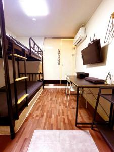 a dorm room with a desk and bunk beds at 24 Guesthouse Sinchon Avenue in Seoul