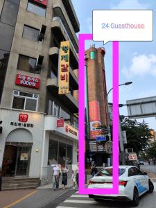 a white car parked in front of a building at 24 Guesthouse Sinchon Avenue in Seoul