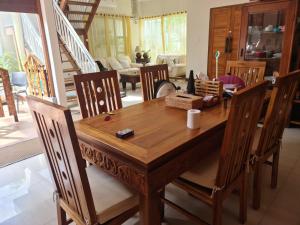 a wooden table and chairs in a living room at Mimosa Villa 4 bedroom di Nusa Dua in Nusa Dua