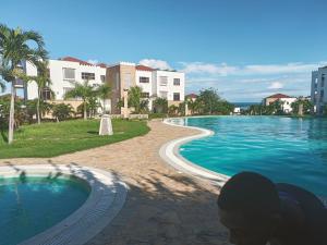 a swimming pool in front of some buildings at Stunning 2 Bed Room Unit with Ocean View in Mariakani