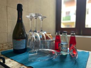a bottle of wine and glasses on a blue towel at EtnaMare petite maison in Mascali