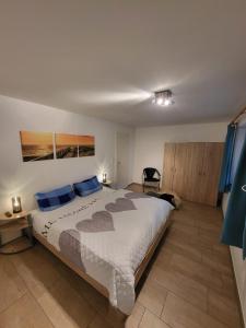 a bedroom with a large bed with blue pillows at Lanckensburg - Ferienwohnung 1 in Altenkirchen