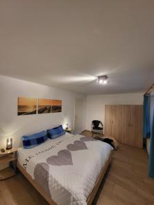 a bedroom with a large bed with blue pillows at Lanckensburg - Ferienwohnung 1 in Altenkirchen