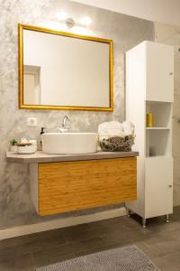 un bagno con lavandino e specchio di Luxury Ultra Central a Sibiu