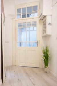 a white door in a room with a plant at Luxury Ultra Central in Sibiu