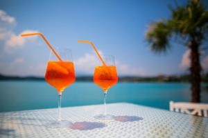 two glasses of orange juice sitting on a table at Seeblick Faaker See in Drobollach am Faaker See