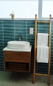 a bathroom with a sink and a towel rack at Sea Breeze Cottage in Cape Town