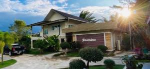 a house with a garage in front of it at Panutsaya Homestay in Wang Nam Khieo