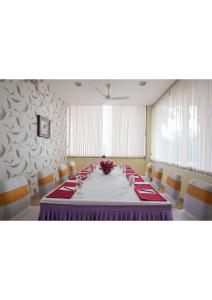 a conference room with a table and chairs at Hotel Aramana in Kāladi