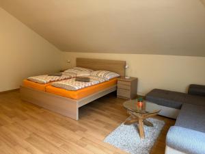 a bedroom with a bed and a couch and a table at Bystra 150 in Bystrá