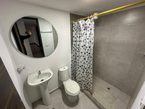 a bathroom with a sink and a toilet and a mirror at Apto 401 / Av. Las Lajas in Ipiales