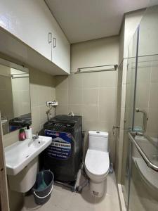a small bathroom with a toilet and a sink at Mall of Asia MOA S Residences , IKEA Pasay in Manila