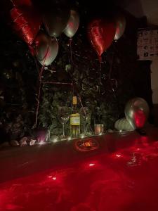 a party with balloons and wine glasses on a table at Studio Apartment Mare with private garden and jacuzzi in Vinkuran