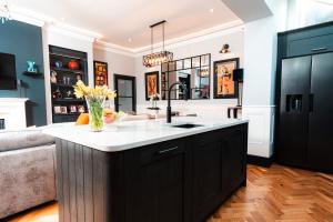 a kitchen with black cabinets and a white counter top at East Cliff in Preston