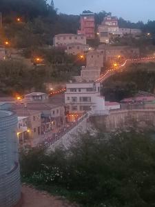 a view of a town at night with lights at Beautiful Guest House II in Chin-sha