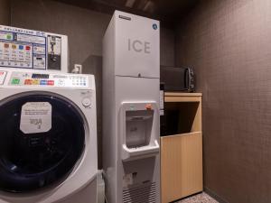 a washer and dryer in a room at Tabist kiki HOTEL KYOTO Sanjo Takakura in Kyoto