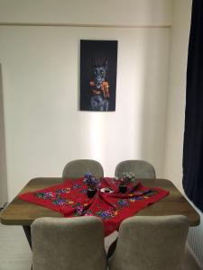 a dining room table with a red blanket on it at Esenboğa Yıldırım Beyazıt Apart in Ankara