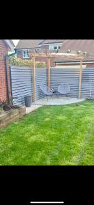 a patio with a picnic table and an umbrella at Provis Wharf Homestay in Buckinghamshire