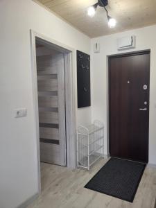 an empty room with a door and a closet at Poilsis dviems in Šiauliai