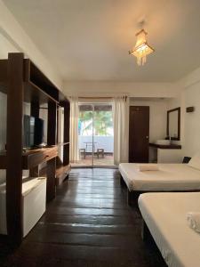 מיטה או מיטות בחדר ב-Boracay Coco Huts