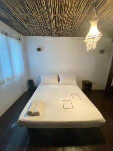 מיטה או מיטות בחדר ב-Boracay Coco Huts