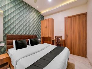 1 dormitorio con 1 cama grande y armario de madera en Collection O Zamzam Residency, en Bhopal