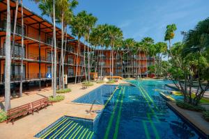 a swimming pool in front of a building at Nongnooch Garden Pattaya Resort in Ban Nong Chap Tao