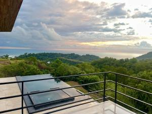 a view of the ocean from the balcony of a house at Prime Hermosa- Ocean View Villa with Infinity Pool in Playa Hermosa